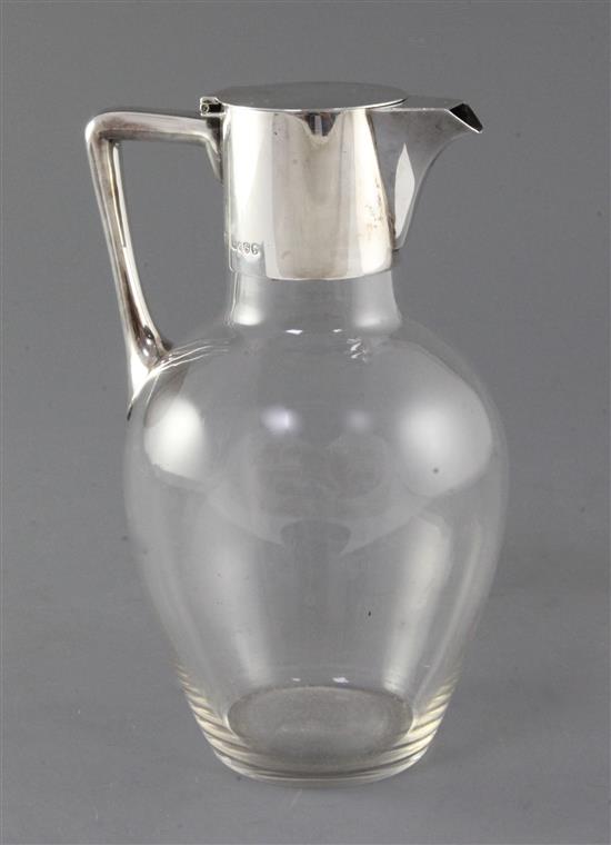 A Victorian silver mounted glass claret jug, in the manner of Christopher Dresser, by Hukin and Heath, 20.5cm.